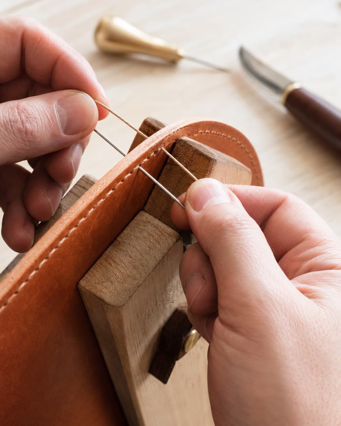 Hand-stitching a leather seam at the Cattle & Co bench